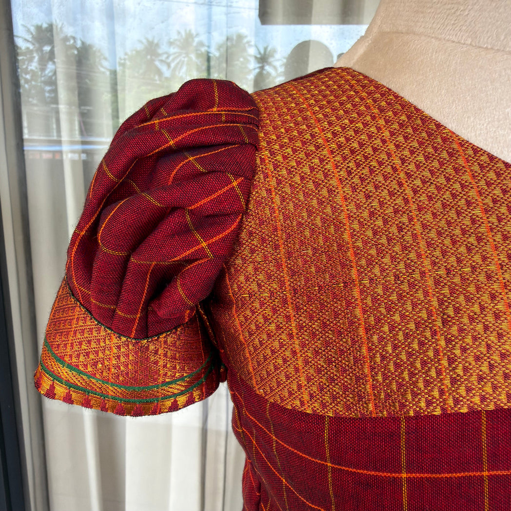 colse up of handwoven Narayanpet check cotton crop top with puff sleeves, golden zari bodice 