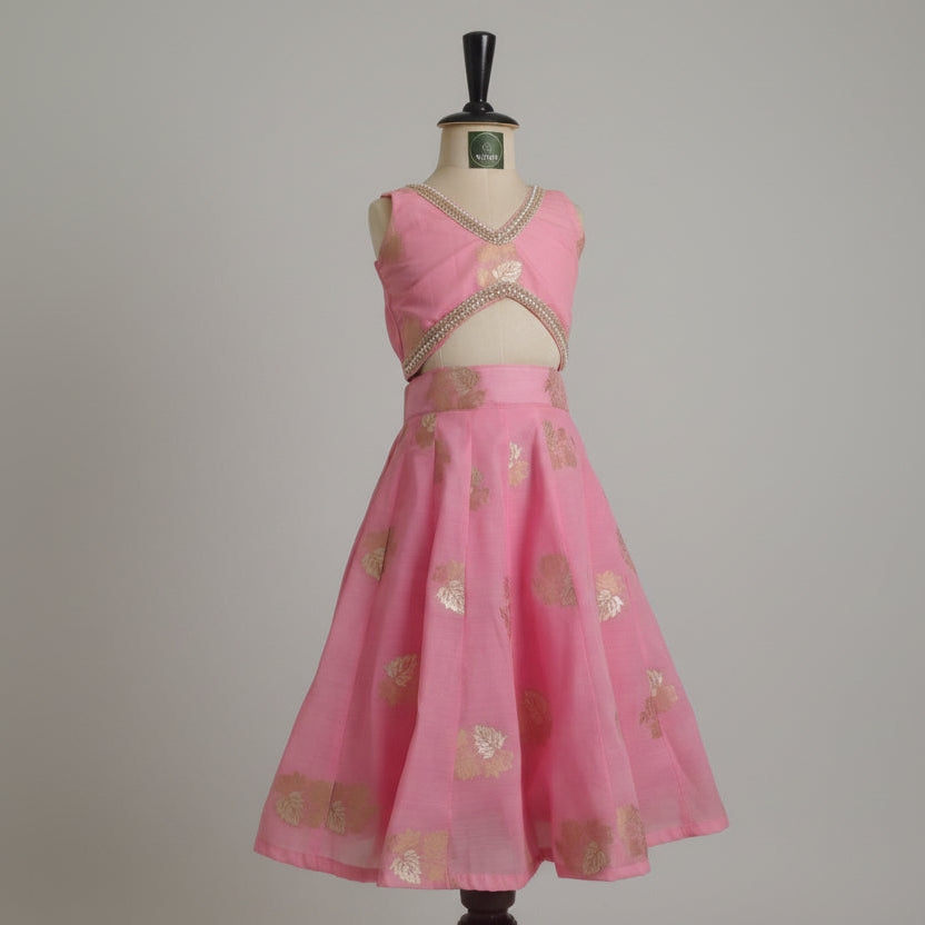 Pink kids lehenga dress with gold patterns .